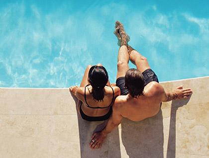 couple sitting by the pool