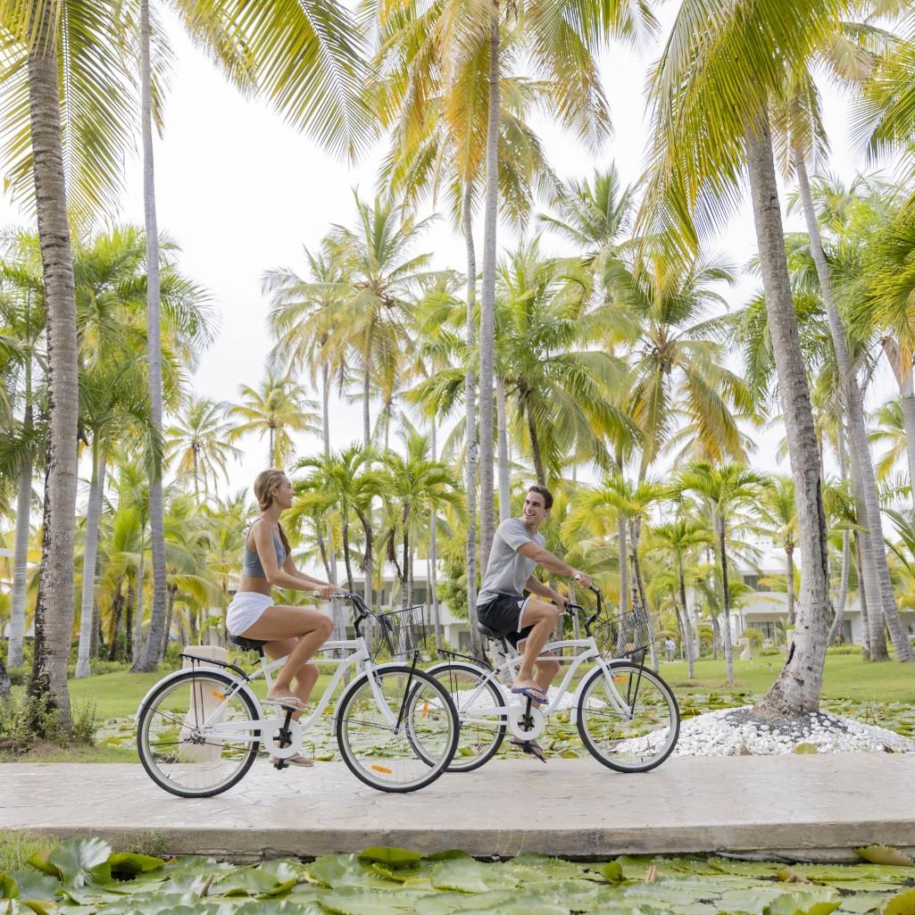 A couple rides bicycles on vacation